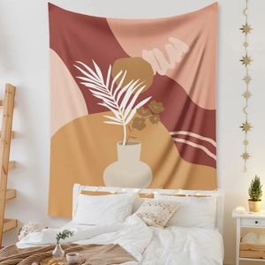 Detail of bohemian wall tapestry featuring abstract vase art in warm terracotta bedroom decor