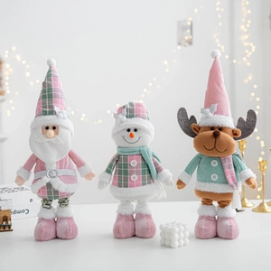 Pink and grey plush Christmas figurines set with Santa, Snowman and Reindeer on white table