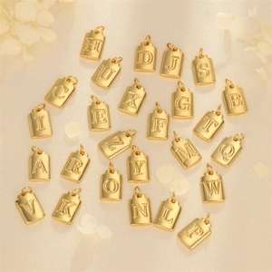 Gold plated rectangular alphabet cube pendants for DIY jewelry making on soft fabric