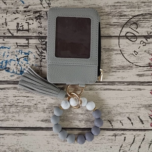 Detail of grey leather wallet with ID window and marble silicone bead wristlet