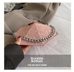 Detail view of the wear-resistant bottom on this pink lace hexagonal crossbody bag
