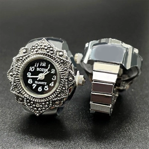 Detailed view of a vintage silver quartz ring watch with embossed floral patterns