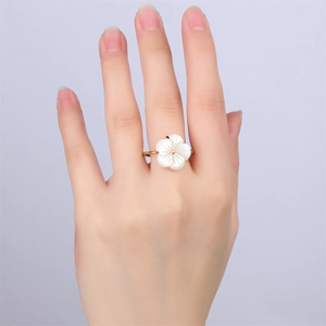 18k gold stainless steel camellia flower ring with mother of pearl petals on finger