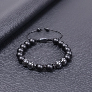 Macro detail of 10mm tiger eye beaded bracelet with zircon inlay on premium leather