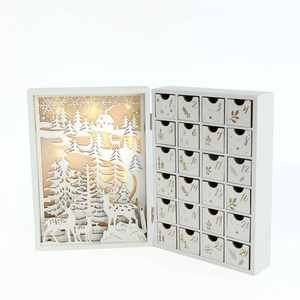 Close-up of wooden LED Christmas Advent Calendar with 24 white drawers and forest deer scene