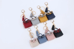 Flat lay macro of colorful owl coin purse keychains in various leather finishes and colors