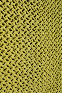Macro shot of yellow-green knit texture showing intricate mesh pattern and fiber detail