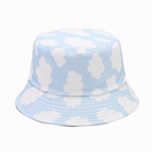 Canvas bucket hat with light blue sky and white cloud patterns for outdoor sun protection