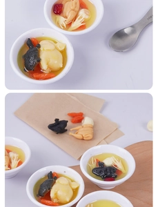 Detailed macro view of miniature herbal chicken soup model with goji berries and turtle