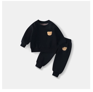 Close-up of kids fleece tracksuit set with cute bear patch embroidery detail