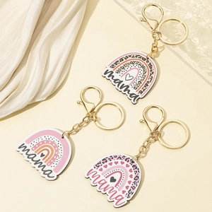 Three leopard print mama rainbow keychains with gold hardware on white silk