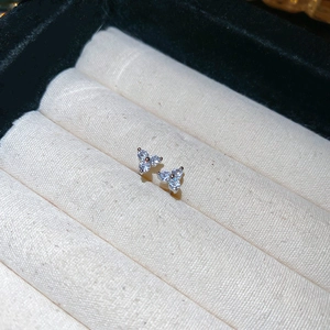 Macro detail of three-petal flower stud earrings with sparkling silver cubic zirconia stones