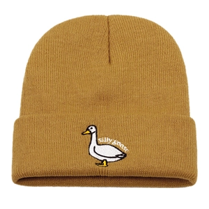 Detail of silly goose embroidery on a mustard yellow ribbed knit beanie for winter