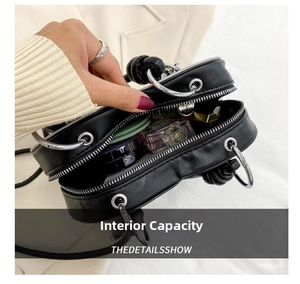 Detailed interior view of a heart-shaped leather crossbody bag with spacious compartments