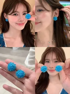 Macro view of handmade sky blue crystal bead cluster earrings on model for summer look