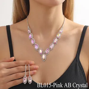 Macro shot of V-shaped pink AB crystal necklace and drop earrings with white stones