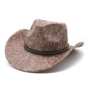 Detail of vintage western cowboy hat with distressed texture and metal stud band