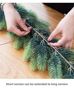 Detail showing artificial pine needle garland being assembled into a longer length