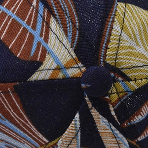Macro shot of colorful leaf patterns on cotton fabric with top button detail
