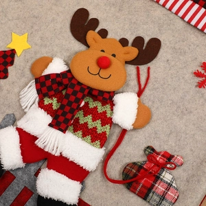 Cartoon reindeer Christmas pendant decoration with plaid scarf on a grey felt background