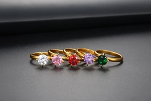 Detailed row of gold rings with colorful zirconia stones in classic four-prong settings
