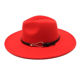 Close-up of red wide-brim wool fedora hat with black belt and golden buckle detail