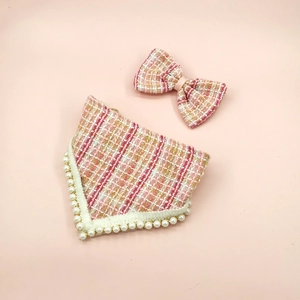 Detailed view of tweed pet bandana and bowtie set with white pearl trim decoration