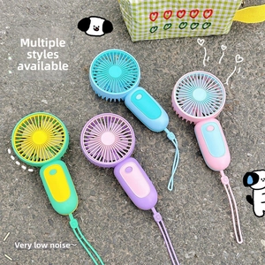 Detail of four colorful portable mini USB fans with matching lanyards on a surface