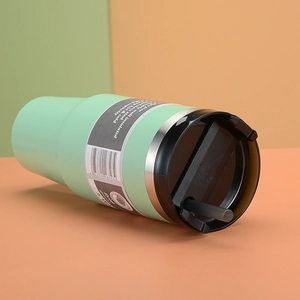 Detail of mint green 30oz insulated tumbler with BPA free label and black straw