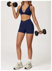 Close-up of navy blue yoga set featuring V-neck sports bra and high-waisted gym shorts