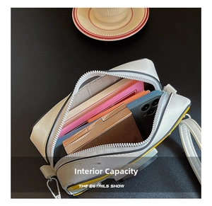 Detail of the camera bag interior showing storage space for phone and makeup items