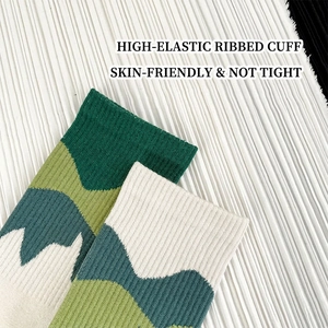 Crew socks with high-elastic ribbed cuffs and green geometric mountain pattern on white