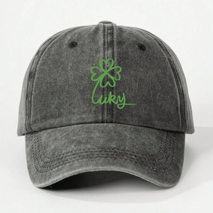 Close-up of grey washed denim baseball cap featuring green Lucky clover embroidery