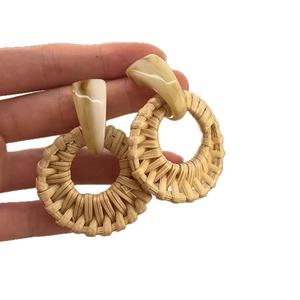 Bohemian rattan hoop earrings with marble resin studs on a clean white background