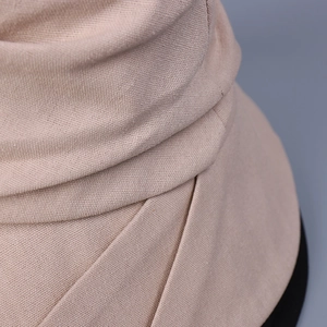 Close-up of breathable beige cotton linen sun hat fabric texture and fine knit details
