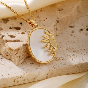 Elegant gold-plated oval pendant with sun relief and mother of pearl inlay on chain