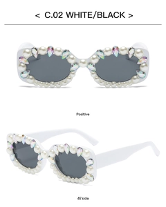 Detail of square white frame sunglasses with pearl accents and rainbow crystal embellishments