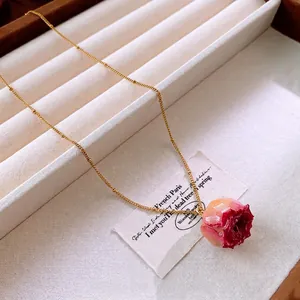 Elegant gold titanium necklace with a natural red rose flower pendant in a French style