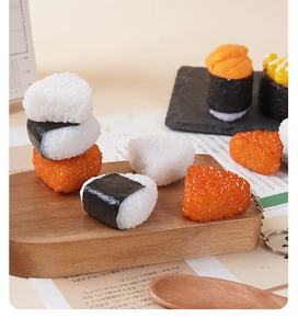 Close-up of lifelike onigiri rice ball keychains with realistic rice texture and seaweed