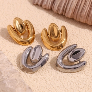Detailed view of 18K gold and silver irregular geometric earrings with faux pearls