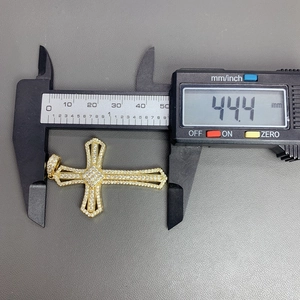Digital caliper measuring the 44.4mm height of the gold cross pendant with cubic zirconia