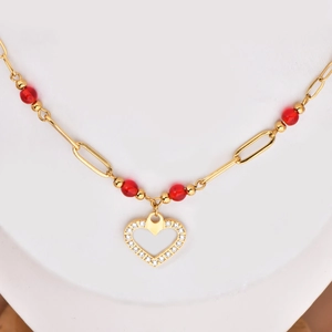 18k gold plated titanium necklace with red beads and sparkling heart pendant on white background