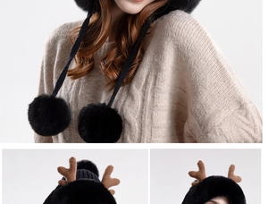 Detail view of plush deer antler hat with pom-pom ties and thick winter lining