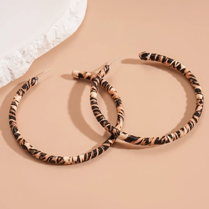 Chic leopard print geometric round hoop earrings with premium leather texture on stone