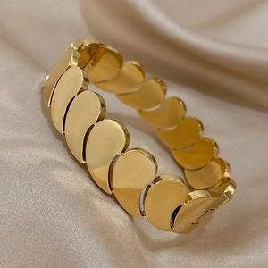 Bracelet multicouche doré à maillons gouttes d'eau sur fond en soie champagne