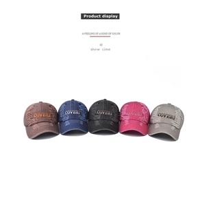 Row of washed cotton baseball caps with distressed edges and embroidered Coveri lettering