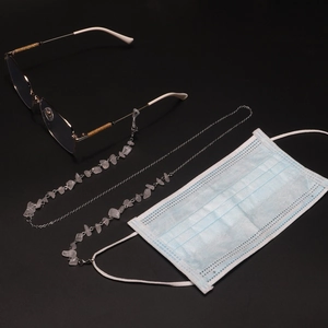 Detail of pink natural stone and silver chain used for glasses and face mask holder