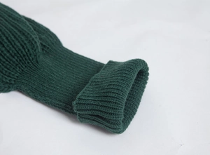 Detailed macro view of dark green knitted ribbed sleeve cuff with texture and elasticity