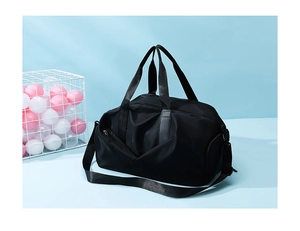 Detail of waterproof black travel bag with side zipper pocket on a light blue background