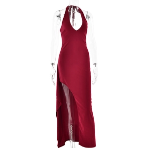 Detail of deep red halter neck maxi dress with a high side slit and soft flowing fabric